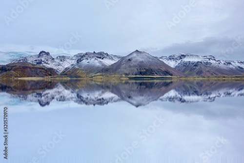 Beautiful scenery Eyjafjallajokull, Iceland with smooth reflection and glacier on the linear of mountains. photo