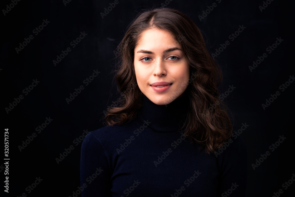 Beautiful young woman portrait at isolated black background