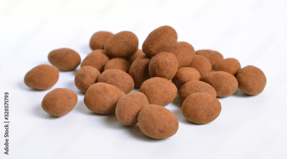 Sweets with almonds and cocoa powder. Isolated On white background Sweets with almonds and cocoa powder. Isolated On white background
