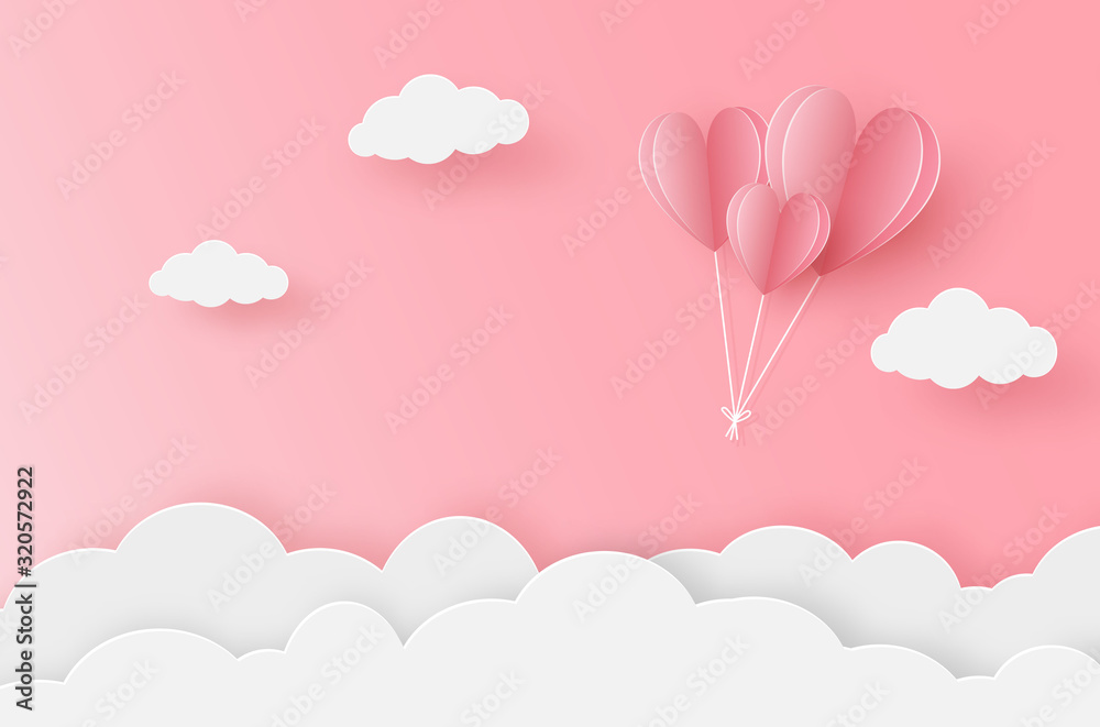 Paper heart balloon flying on the pink sky