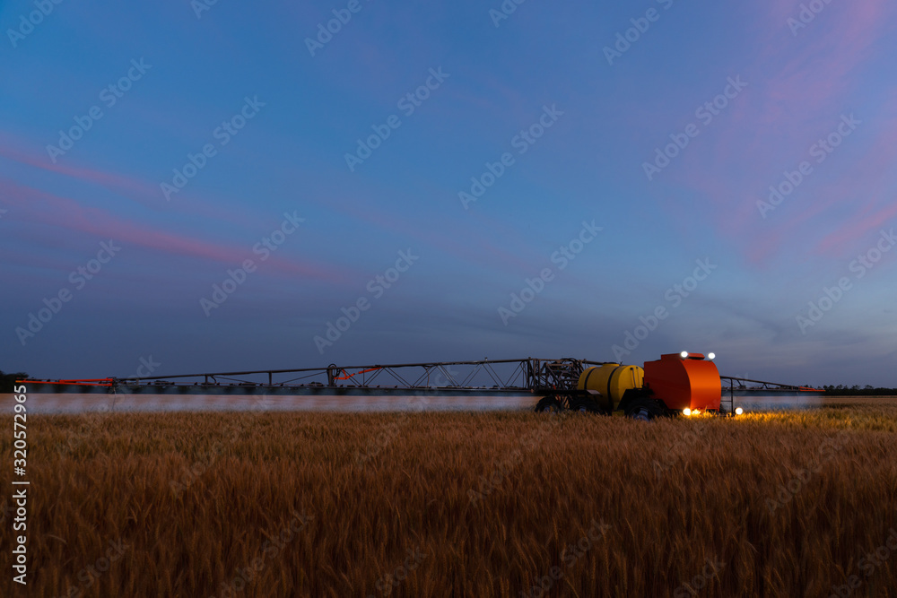Fototapeta premium Autonomous machine for spraying pesticides and herbicides in the field at work. Smart farming