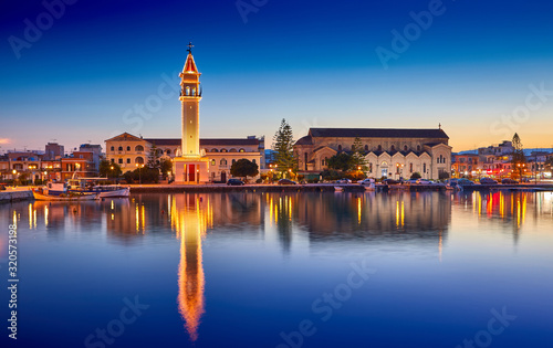View on town hall and Saint Dionysios Church, Ionian Sea, Zakynthos island, Greece, Europe. Amazing sunset view. Zakynthos tower in the evening lights. The main harbor of the city. Incredibly sunrise.