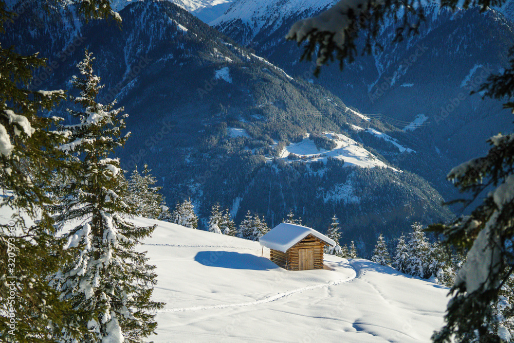 Holzhütte  in den Bergen im Schnee