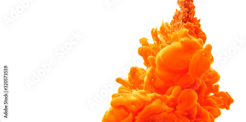 Abstract form orange color ink in water on an isolated white background with copy space