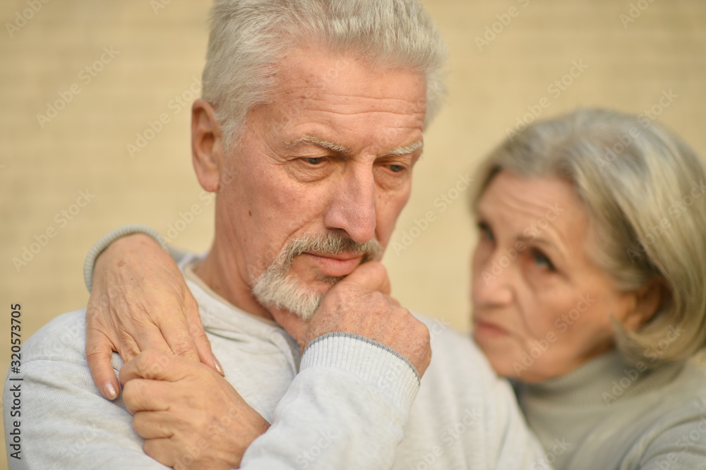 Portrait of sad thoughtful senior couple in park Portrait of sad thoughtful senior couple in park