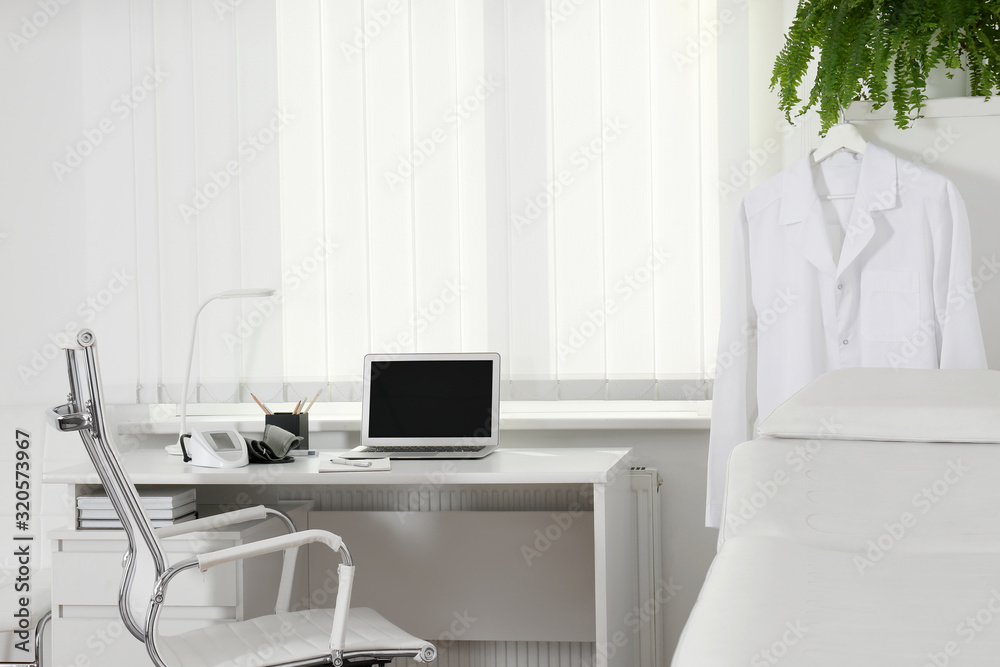 Doctor's workplace near window in medical office Doctor's workplace near window in medical office