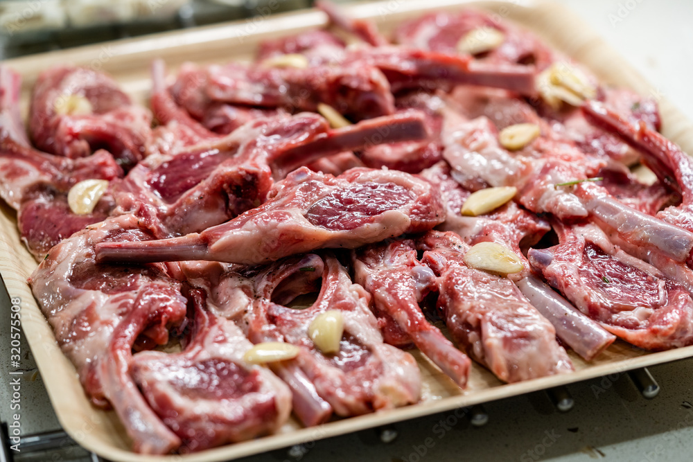Raw Meat Marinated Lamb Chops on Tray / Marinating Before Cooking. Raw Meat Marinated Lamb Chops on Tray / Marinating Before Cooking.