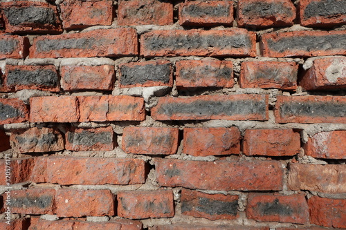 Brick wall. Wall of old red brick. The ruins of ancient buildings. The background is brick.