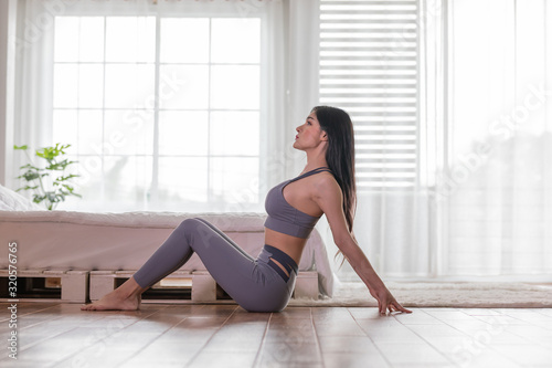 Happy Athletic Asian woman practice yoga stretching pose for stretching muscle for warm up with meditation smile after wake up in the morning Feeling so comfortable and relax,Healthcare Concept