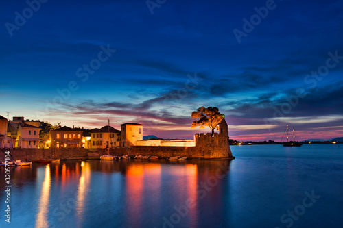 Panoramic view of the illuminated port of Nafpaktos, Greece. Nafpaktos is a popular tourist destination and a picturesque coastal town, former municipality in Aetolia-Acarnania, West Greece photo