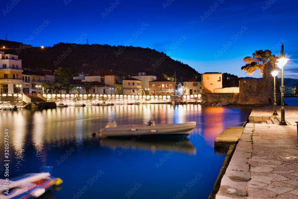 Panoramic view of the illuminated port of Nafpaktos, Greece. Nafpaktos is a popular tourist destination and a picturesque coastal town, former municipality in Aetolia-Acarnania, West Greece