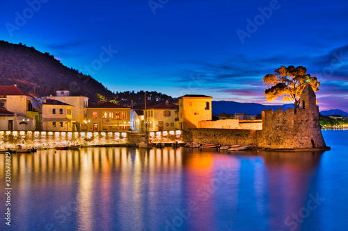 Fototapeta Naklejka Na Ścianę i Meble -  Panoramic view of the illuminated port of Nafpaktos, Greece. Nafpaktos is a popular tourist destination and a picturesque coastal town, former municipality in Aetolia-Acarnania, West Greece
