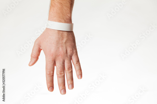Hand with white wristband mockup. Empty ticket wrist band design.