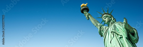 Statue of Liberty in New York, USA. Blue sky panoramic background with copy space, New York City web banner © Delphotostock