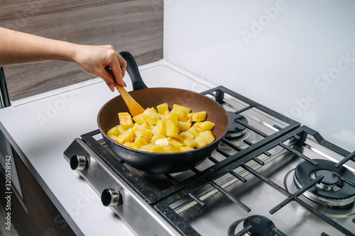 Fried potatoes at home in a frying pan
