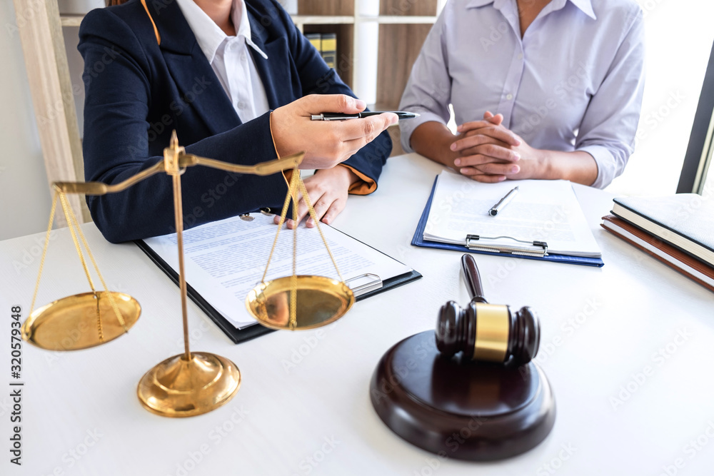 Professional female lawyer or counselor discussing negotiation legal case with client meeting with document contract in office, law and justice, attorney, lawsuit concept Professional female lawyer or counselor discussing negotiation legal case with client meeting with document contract in office, law and justice, attorney, lawsuit concept