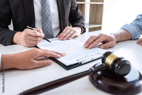 Young couple telling their problems in the courthouse to getting divorced or premarital agreement in lawyers office, deciding on marriage divorce concept