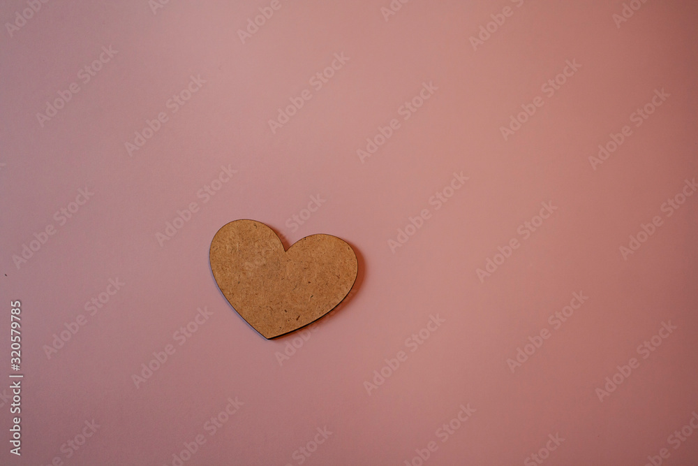 heart made of plywood on a pink background