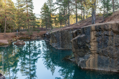 Old abandoned silver mine with blue, emerald water on a sunny evening. silverberg in Sweden. selective focus