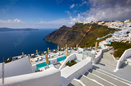 Fira town on Santorini island  Greece. Incredibly romantic sunrise on Santorini. Oia village in the sun light. Amazing sunset view with white houses. Island of lovers