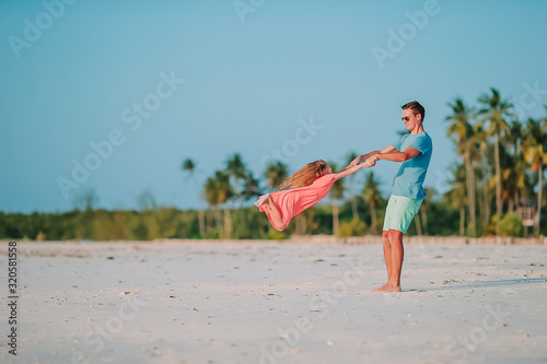 Photography Little girl and happy dad having fun during beach vacation