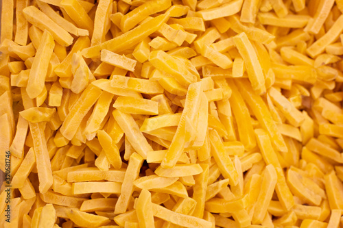 texture of frozen French fries, sliced potatoes. Food background for your unique text.