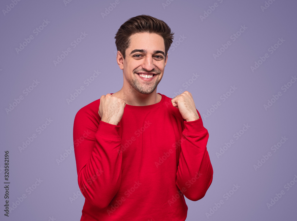 Excited young man making yes gesture with hands Excited young man making yes gesture with hands