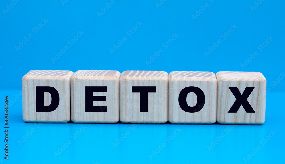 concept word detox on wooden cubes on a blue background concept word detox on wooden cubes on a blue background