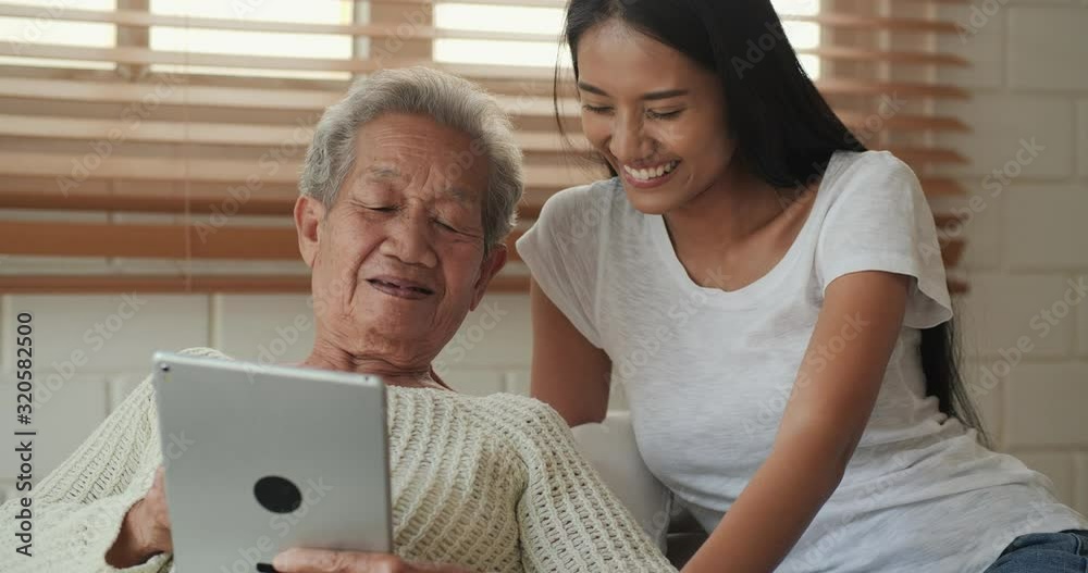 Woman teaching her mother to use tablet at home. Lifestyle, Technology and Leisure concept. Woman teaching her mother to use tablet at home. Lifestyle, Technology and Leisure concept.