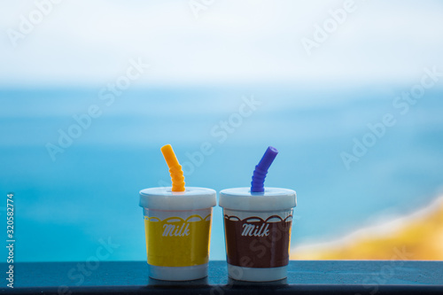 two milk shakes with the blue sea and beach on the background. typical vacation feeling