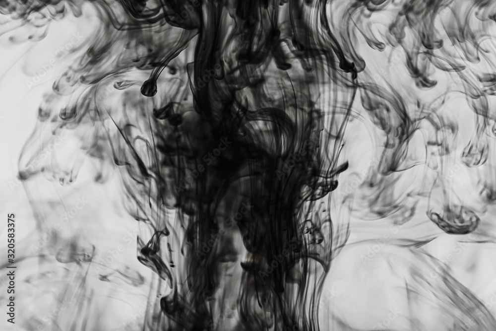 Abstract black and white background: ink effectively spread in the water. Copyspace.