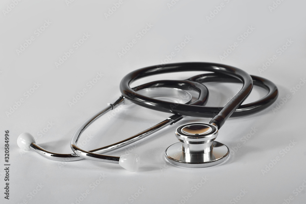 Stethoscope on a white background. Medical equipment on the table.