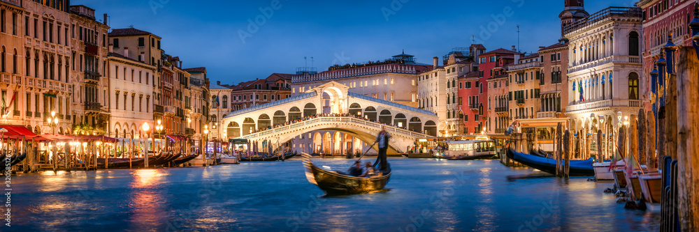 Romantic gondola ride near Rialto Bridge in Venice, Italy