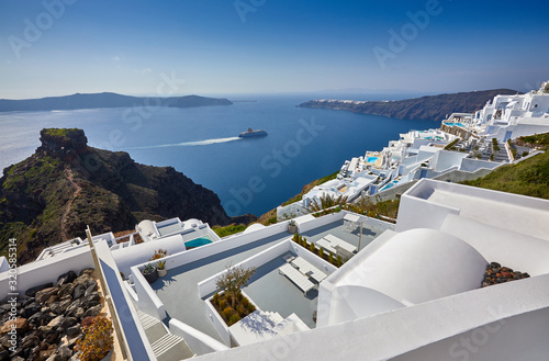Fira town on Santorini island  Greece. Incredibly romantic sunrise on Santorini. Oia village in the sun light. Amazing sunset view with white houses. Island lovers