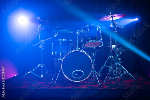 Drum kit on a stage with Stage Lights around it. Professional musical instruments. 