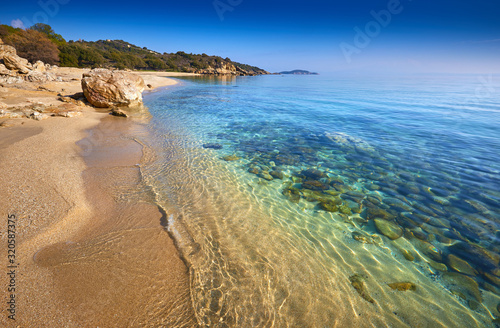 Fototapeta Naklejka Na Ścianę i Meble -  Amazing sunset view on Proti ammoudia beach near Olympiada town summer resort, Kavala region, Greece.. Incredibly romantic sunrise on the beach, Ionian Sea. View of the ocean. Tropical beach
