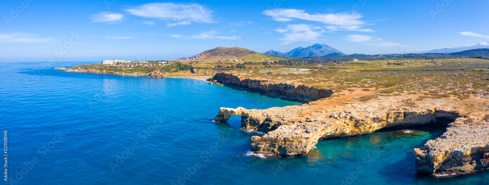 Aerial view of beautiful natural big rock arch Kamara Geropotamou, near sandy beach and river,  Rethimno, Crete, Greece.