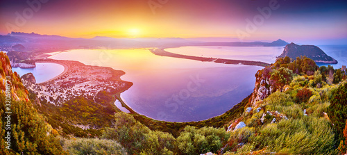 Fototapeta Naklejka Na Ścianę i Meble -  Amazing sunrise view with multicolored clouds from Navarino Castle. Romantic sunset on Voidokilia beach, Ionian Sea, Pilos town location, Greece, Europe. View of the ocean through the rocky shore