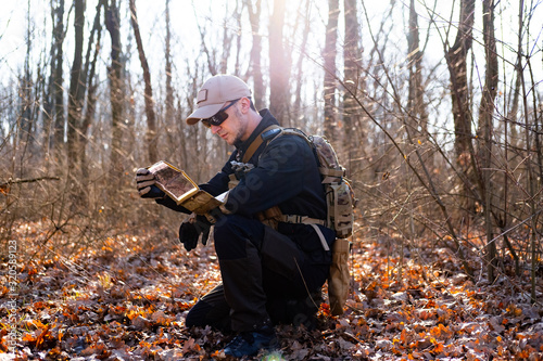 Male from private military company with rifle in the forest