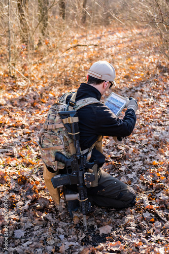 Male from private military company with rifle in the forest