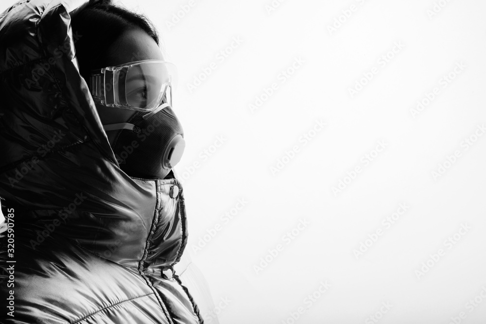 Black and white portrait of young female researcher. Woman in protective medical mask, respirator and suit. Free space for text. White background. Healthcare concept. Coronavirus 2019-nCov. Black and white portrait of young female researcher. Woman in protective medical mask, respirator and suit. Free space for text. White background. Healthcare concept. Coronavirus 2019-nCov.