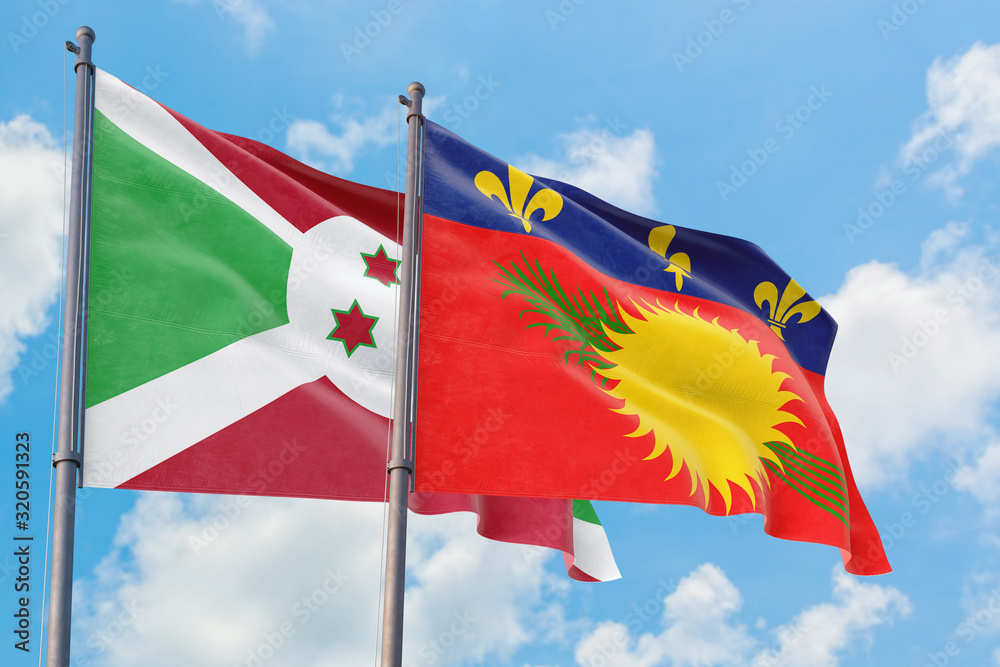 Guadeloupe and Burundi flags waving in the wind against white cloudy blue sky together. Diplomacy concept, international relations. Guadeloupe and Burundi flags waving in the wind against white cloudy blue sky together. Diplomacy concept, international relations.