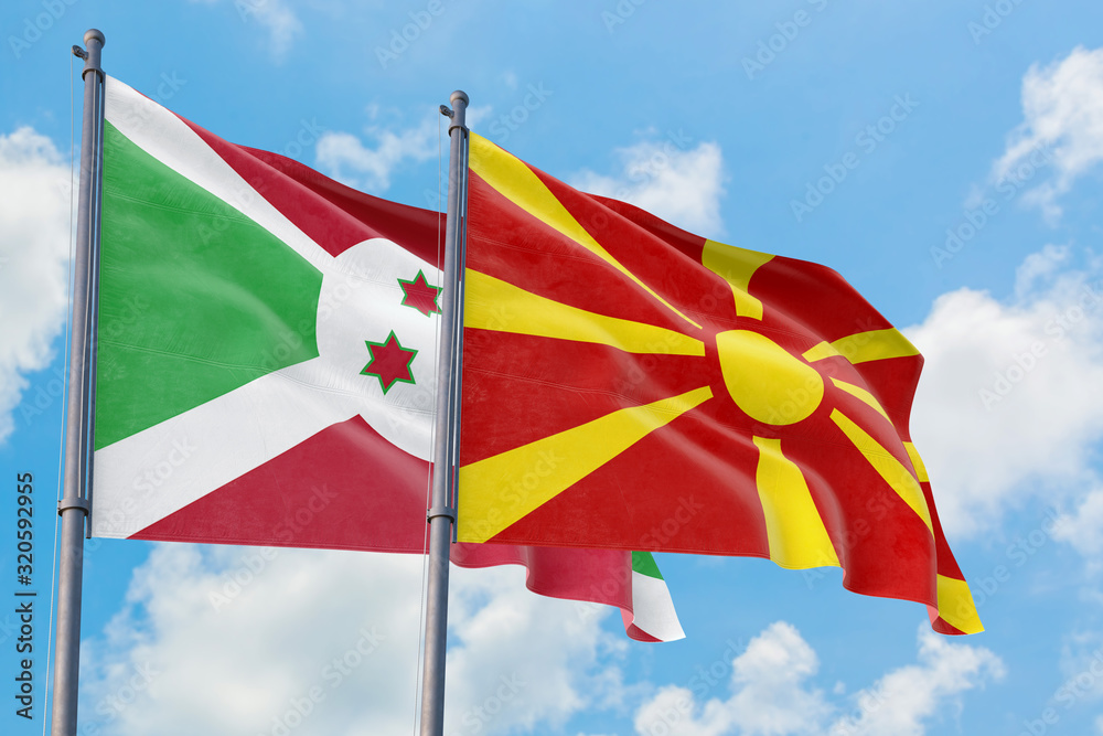 Macedonia and Burundi flags waving in the wind against white cloudy blue sky together. Diplomacy concept, international relations. Macedonia and Burundi flags waving in the wind against white cloudy blue sky together. Diplomacy concept, international relations.