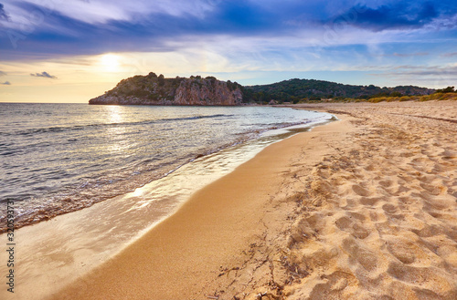 Fototapeta Naklejka Na Ścianę i Meble -  Amazing sunset view with multicolored clouds. Incredibly romantic sunrise on Voidokilia beach, Ionian Sea, Pilos town location, Greece, Europe. View of the ocean. Tropical beach