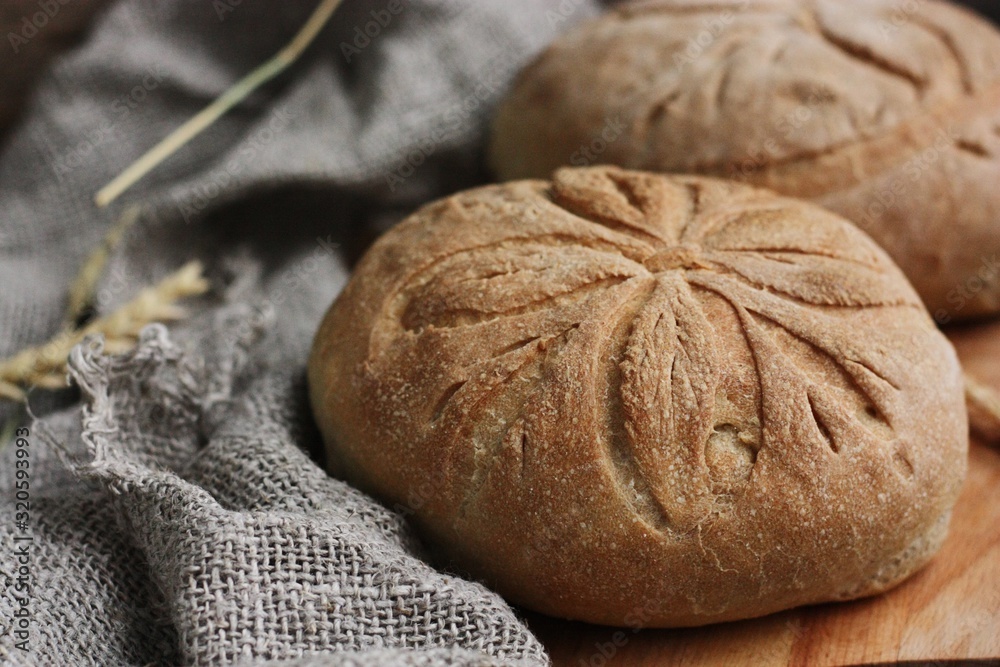 Fototapeta premium Delicious white bread with rye on the table 