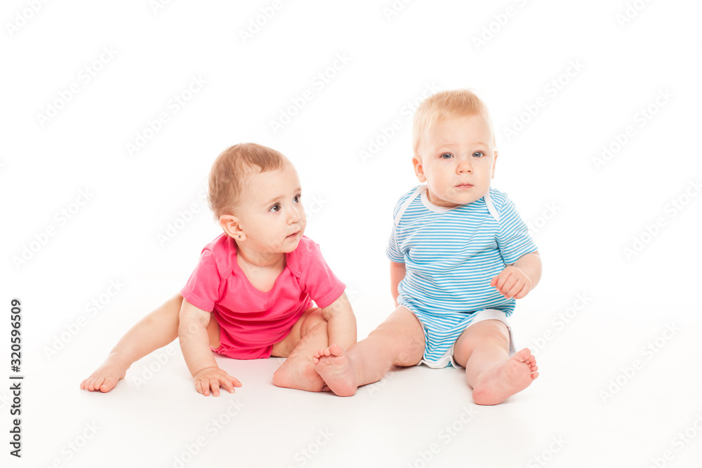Lovely baby boy and baby girl are playing isolated over white background Lovely baby boy and baby girl are playing isolated over white background