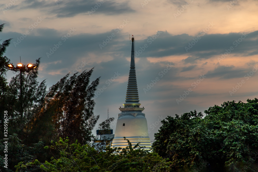 The main big white pagoda at evening of sunset that is a landmark of Wat Prayurawongsawas Warawihan.