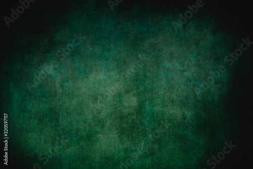 Dark green grungy backdrop or texture