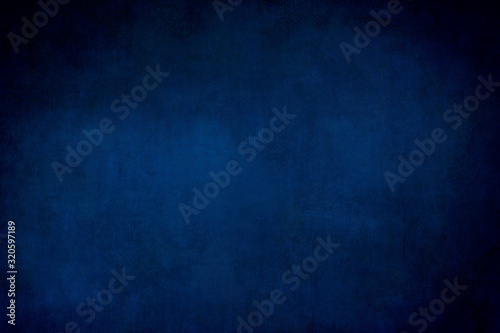 Dark blue grungy backdrop or texture