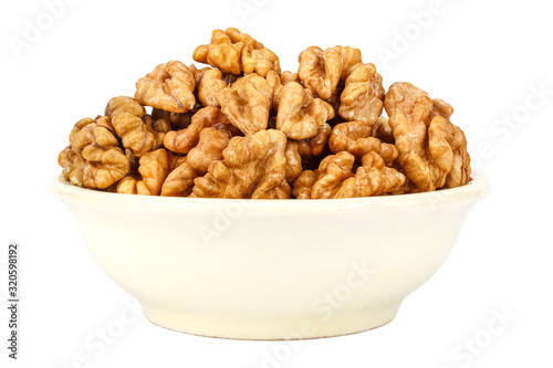 Peeled walnuts in the small ceramic bowl isolated on white background